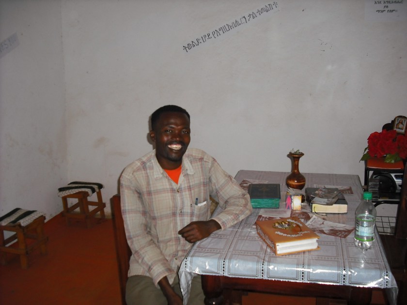 Worku at the table in his home